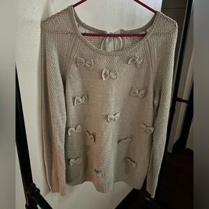 Cute sweater with bows and a keyhole back!